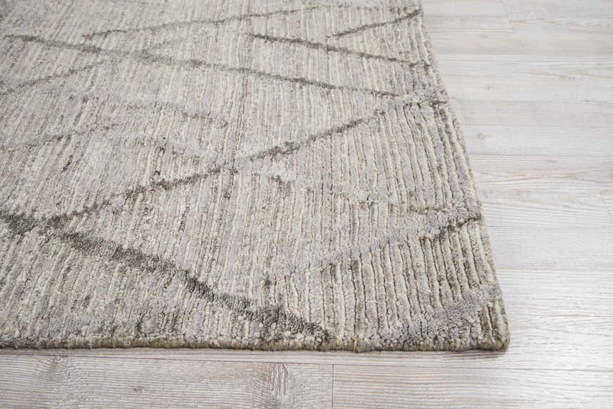 Close-up of the handmade Nourison OCEAN Stone rug; sandstone color, mid-century modern style, textured design.