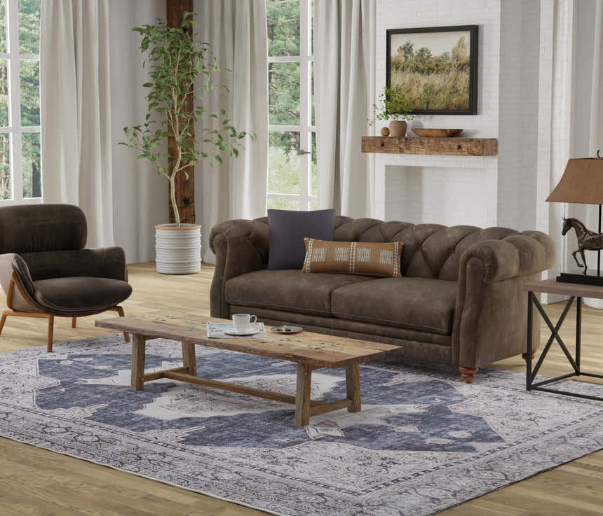 Living room scene with a Feizy Percy Gray/Ivory/Taupe rug, brown sofa, wood coffee table, and farmhouse decor. Roomscene-Rectangle