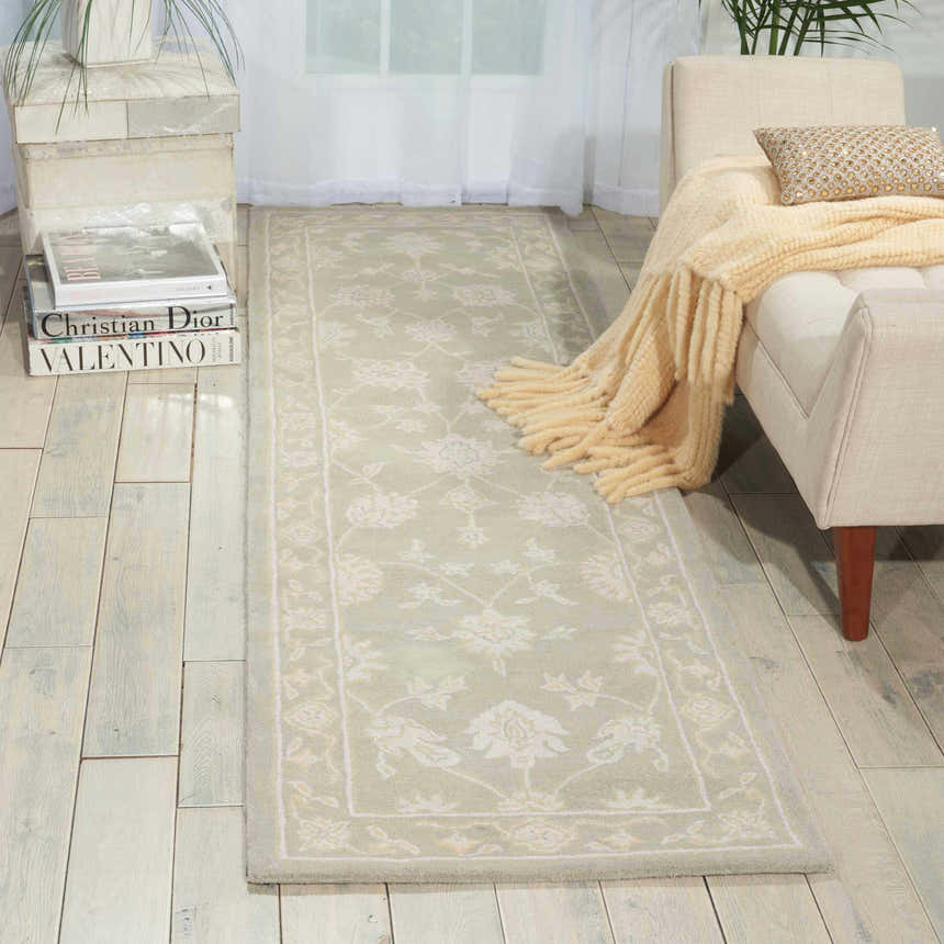 Entryway with Nourison Zephyr Silver rug, cream bench, and light wood floors for a bright, airy, and stylish look.