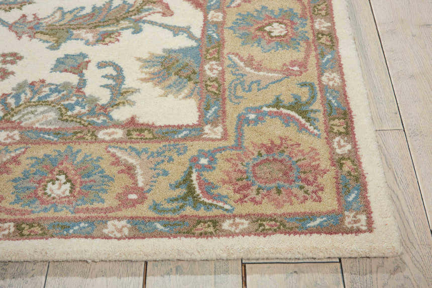 Close-up of the Nourison India House Ivory/Gold Persian rug, showcasing its wool texture and floral pattern in ivory, gold, pink, and blue.
