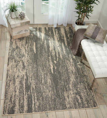 Entryway with Barclay Butera Lido Grey Cream rug, white bench, wood floors, and plants. Modern, neutral decor.