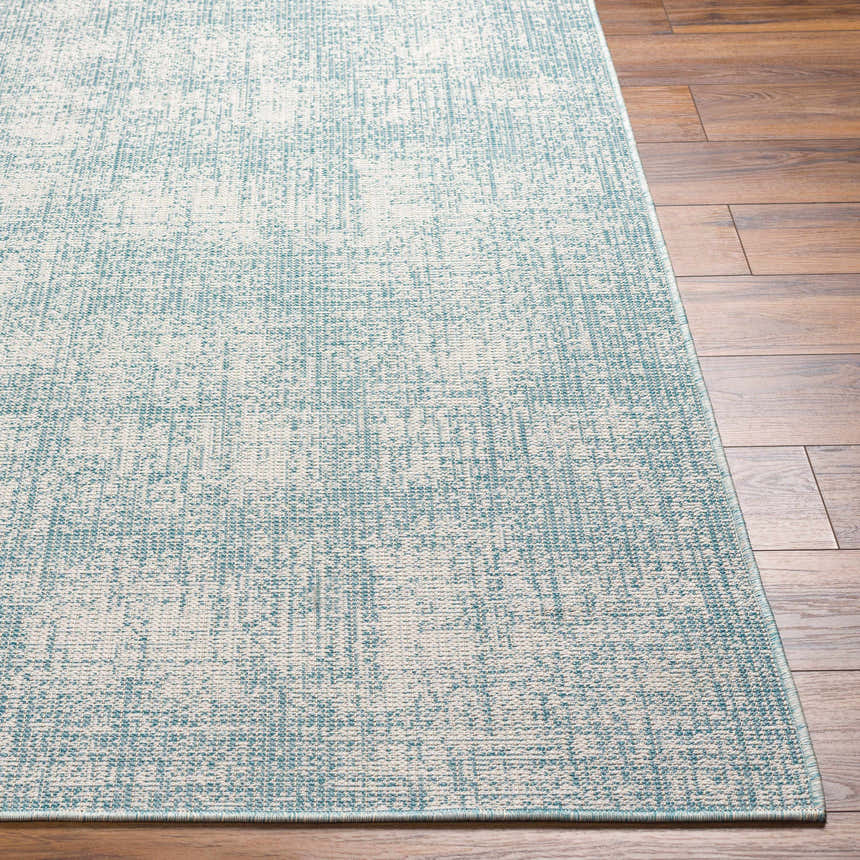 Close-up of the Rhea Area Rug in denim and natural gray, showing the contemporary machine woven texture. Front