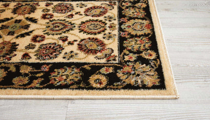 Close-up of the Nourison Delano Ivory Black rug showing floral pattern, black border, and ivory, chestnut, and red colors.