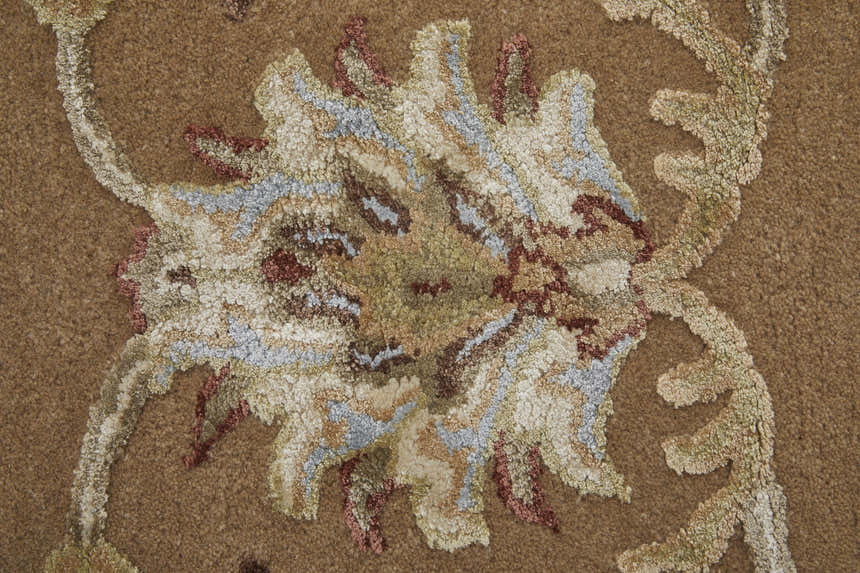 Close-up of the Feizy Prescott rug in tan and ivory, showcasing the floral and botanical design and hand-tufted texture. Texture