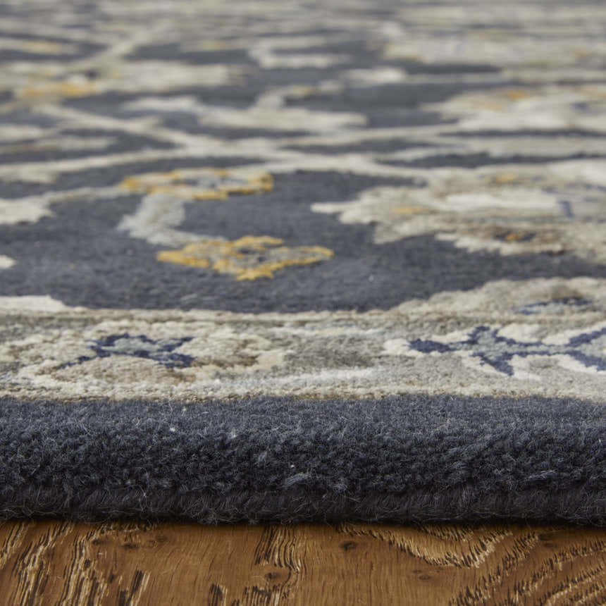 Close-up of Feizy Prescott rug showing blue, silver, and gray floral pattern and hand-tufted texture. Pile