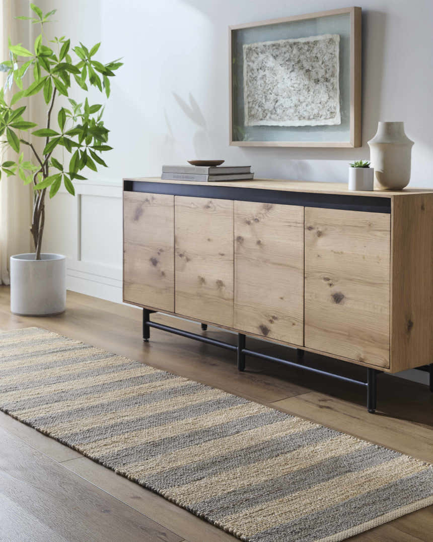 Entryway with camel and natural jute striped Ilkay Jute Area Rug runner, wood console table, and potted plant. Roomscene-Runner