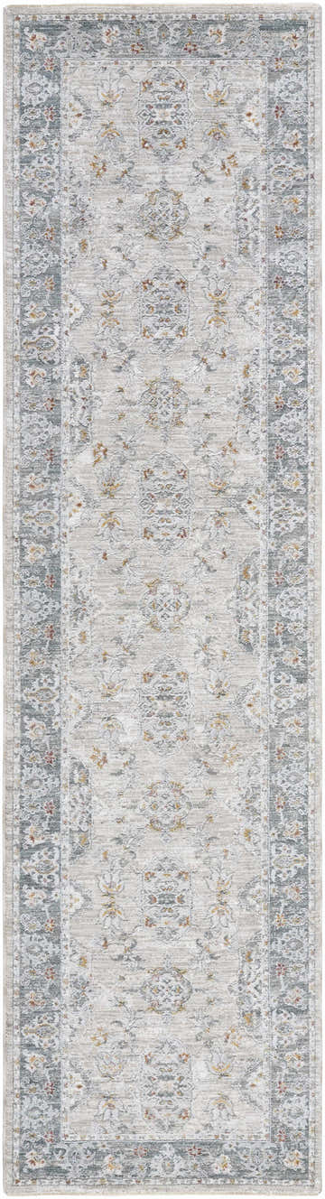 Close-up of the Greco Textured Rug with Fringes. Features a traditional, light gray floral pattern and a textured finish. Design-Runner-2710