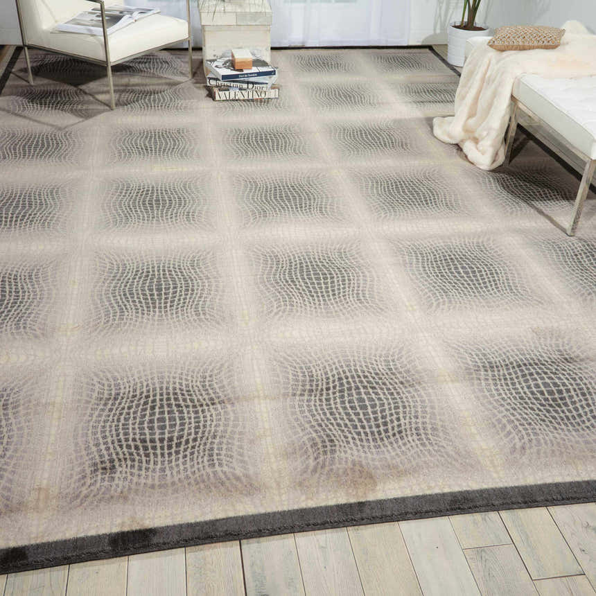 Modern living room with a Nourison Utopia Shell rug, white furniture, and light wood floors.