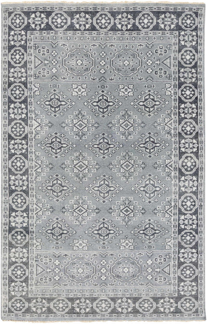 Close-up of the Sherwood Area Rug. Hand-knotted wool rug in ice blue, ink blue, and teal with a traditional geometric pattern. Design-Rectangle-5686