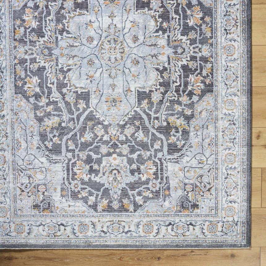 Close-up of the Hayfa Area Rug featuring a traditional gray, light blue, and gold floral pattern on a wood floor. Corner