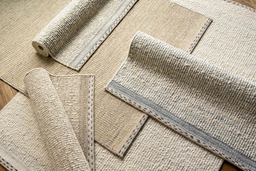 Close-up of the Penticton Cream Flat Woven Wool Rug. Features a textured, neutral beige and cream design with gray accents. Styleshot