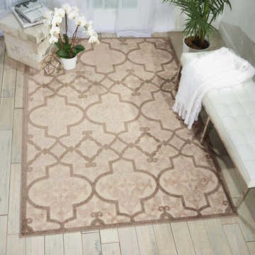Styled room featuring Nourison Aloha Cream Bohemian Area Rug with cream and brown geometric pattern.