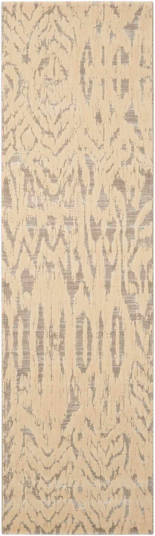 Close-up of Nourison Nepal Ivory/Grey rug. Vintage style with chestnut accents and a distressed, abstract pattern. Wool texture.