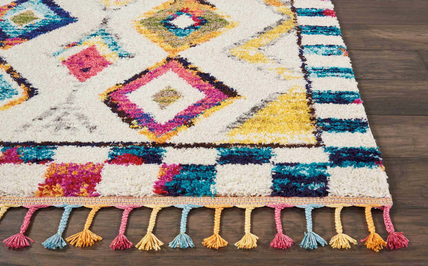 Close-up of the Nourison Nomad Ivory Multicolor Tribal Area Rug with diamond pattern and colorful tassels.