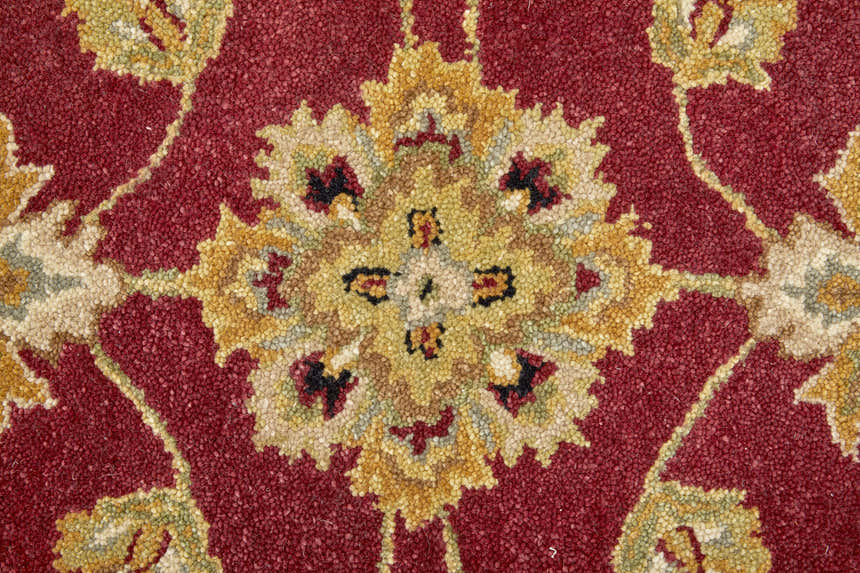 Close-up of the Feizy Wagner Rug showcasing its traditional floral pattern in red, gold, and black wool. Texture
