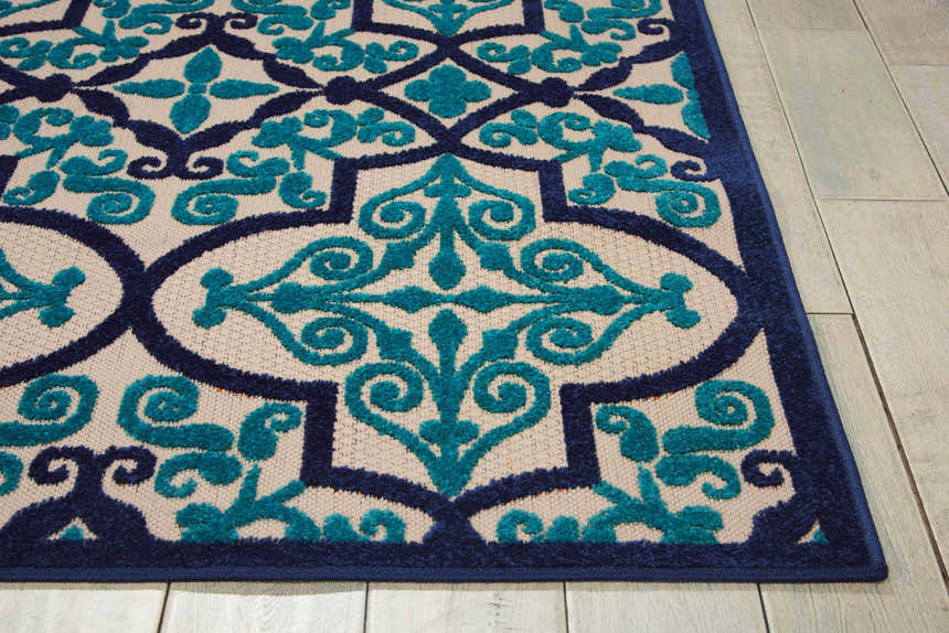 Close-up of the Nourison Aloha Navy Bohemian Area Rug showing the navy and teal floral pattern and texture.