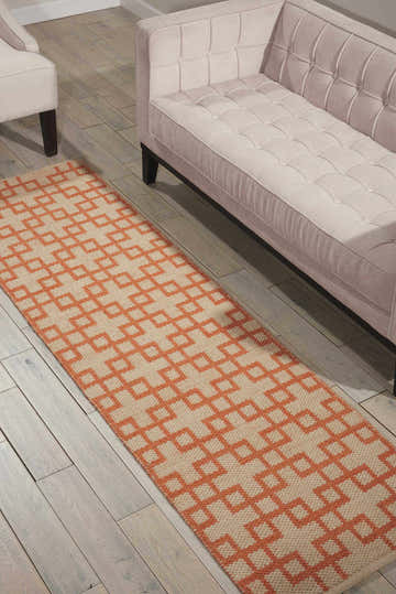 Living room scene with a Barclay Butera Maze Mango runner rug, beige sofa, and light wood floors.