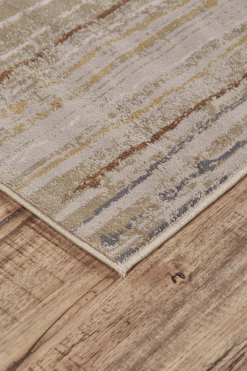 Close up of Feizy Cannes Transitional Stripes Rug in tan, gray, and brown on wood floor. Corner