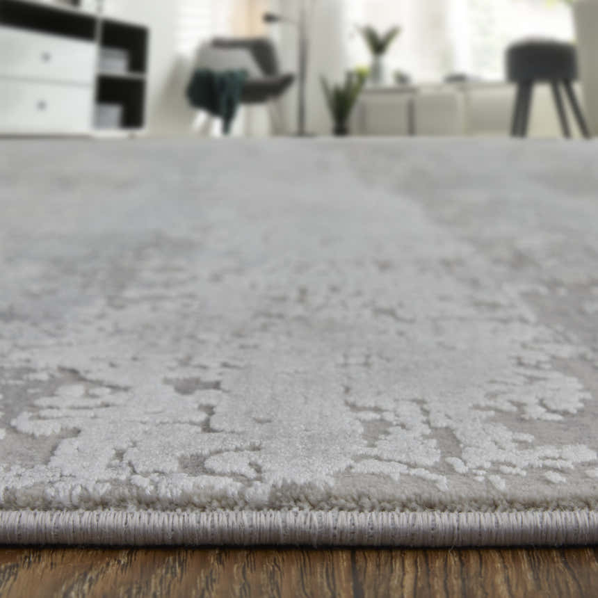 Close-up of Feizy Cadiz Taupe/Gray/Silver Area Rug showing abstract pattern and texture in a modern living room. Pile