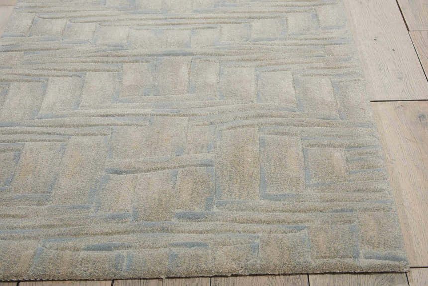 Close-up of the Nourison Moda Breeze Botanical Indoor Area Rug, breeze color, with a geometric pattern and textured wool.