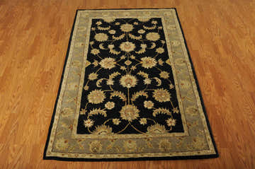 Close-up of the handmade Nourison India House Black Persian rug, featuring a floral pattern and wool texture.