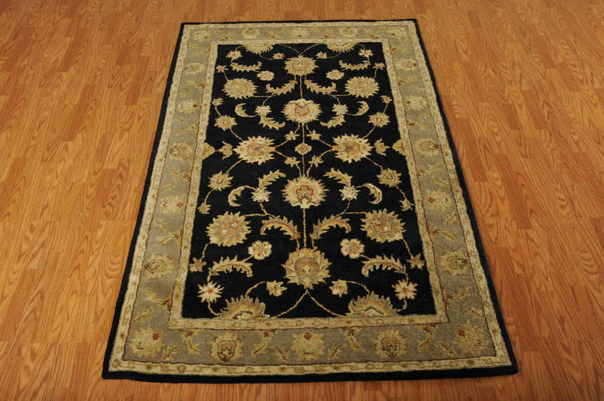 Close-up of the handmade Nourison India House Black Persian rug, featuring a floral pattern and wool texture.