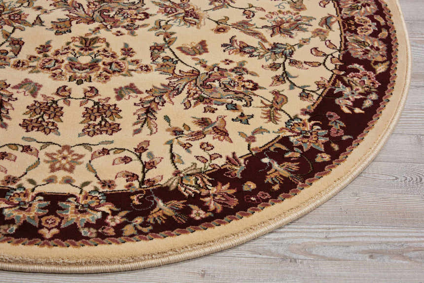 Close up of the Nourison Antiquities Ivory Persian rug showing chestnut border and floral pattern.