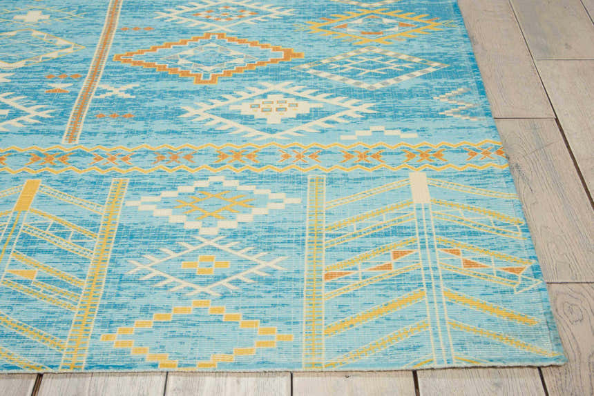 Close-up of Nourison Madera Sky Blue Tribal Rug. Geometric pattern in sky blue, gold, and white.