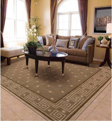 Living room with brown sofa and Nourison Cosmopolitan Chestnut Persian rug. The rug features a Greek key border.