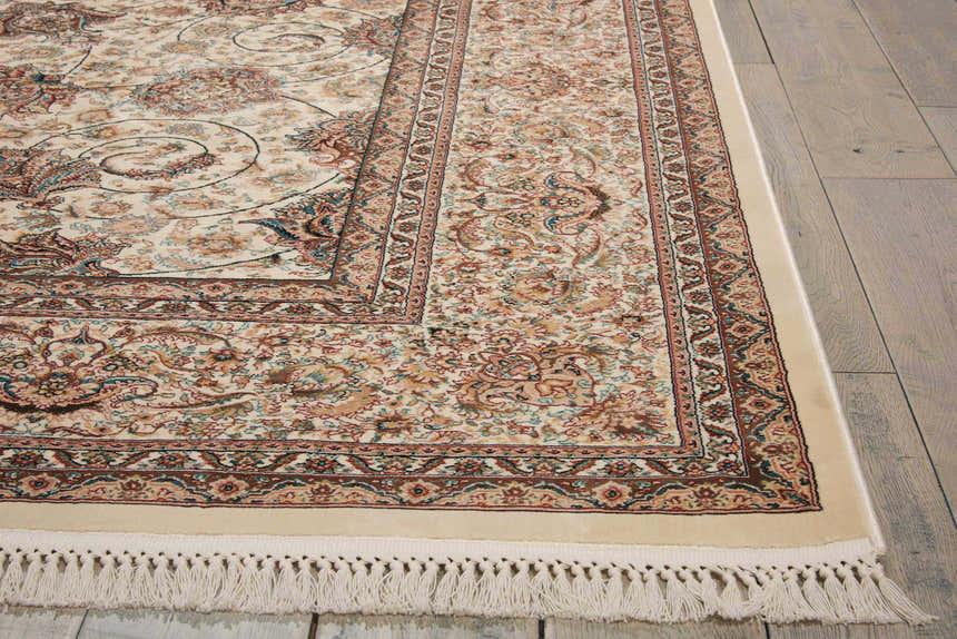 Close-up of the cream Nourison Persian Palace rug. Features a traditional Persian pattern with brown, tan, and blue floral accents.
