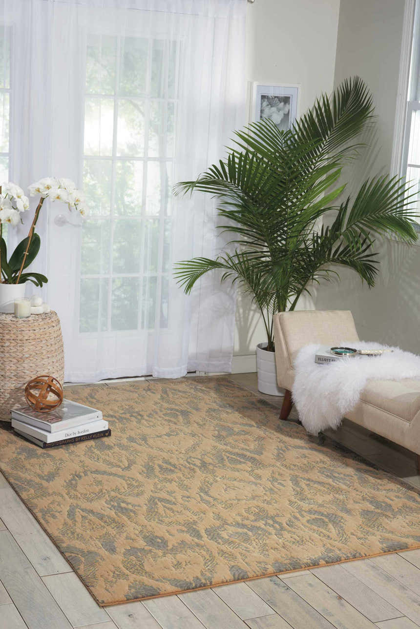 Sunlit room with Nourison Nepal Beige Slate Vintage rug, chaise lounge, plants, and sheer curtains.