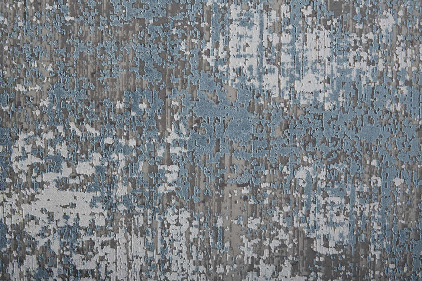 Close-up of the Feizy Cadiz rug. Abstract design in blue, gray, and silver. Contemporary style with textured pattern. Texture