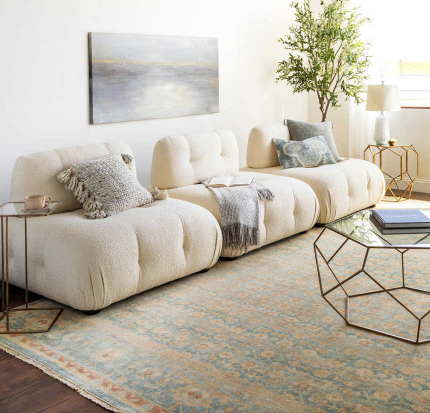 Living room with a cream modular sofa and the brick red and seafoam Papakura Area Rug. Roomscene-Rectangle