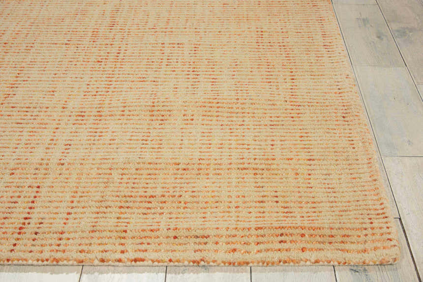 Close-up of the handmade Barclay Butera Intermix Wheat area rug. Peach tones and wool texture visible.