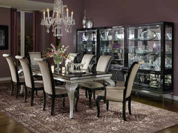 Elegant dining room with Michael Amini Glistening Nights Grey rug, chandelier, and black display cabinet.