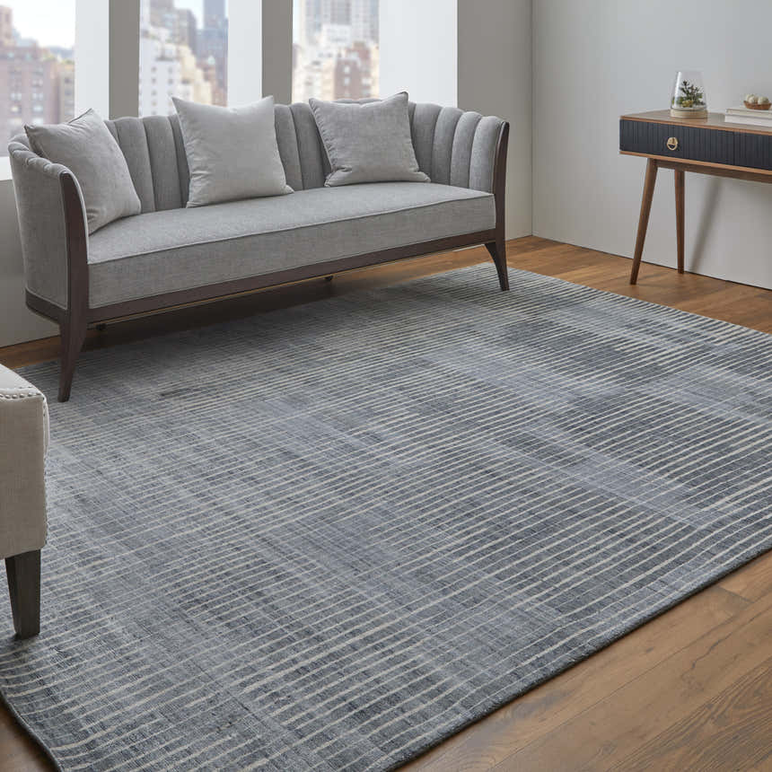 Living room scene with gray sofa and Feizy Eastfield Blue/Ivory/Gray rug featuring a modern abstract grid design. Roomscene-Rectangle