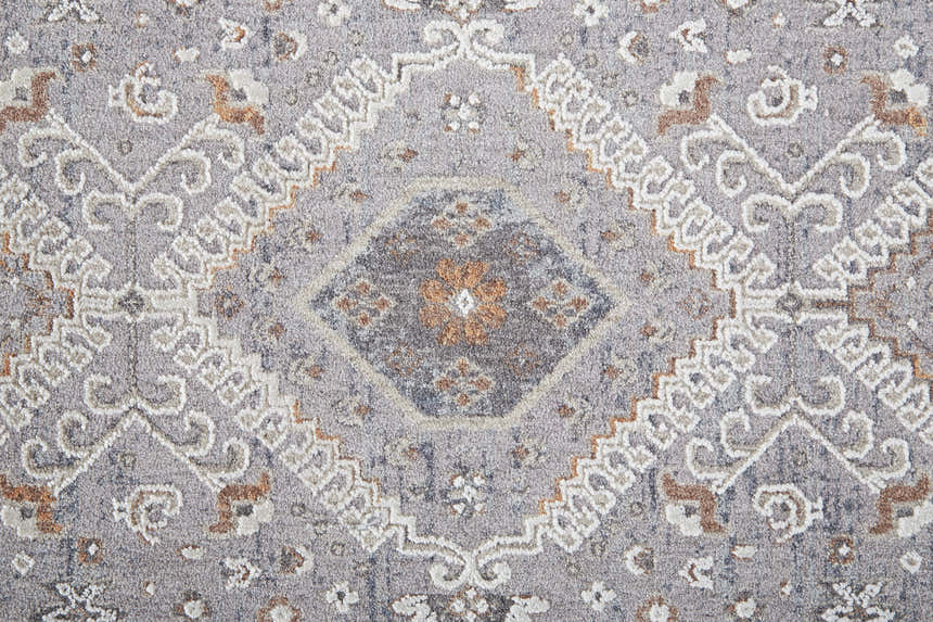Close-up of Feizy Francisco rug. Gray rug with ivory and orange medallion pattern. Transitional style. Texture