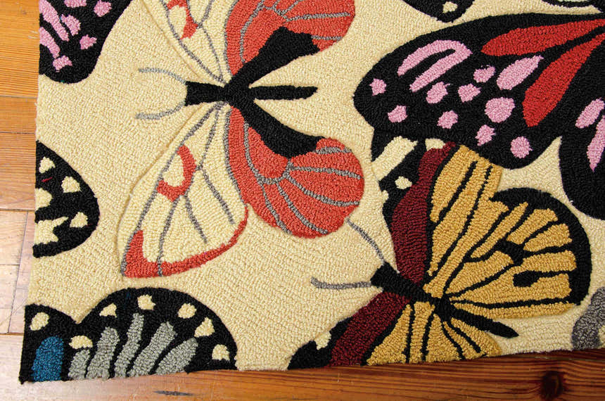 Close-up of the Nourison Fantasy Beige Floral Indoor Area Rug, featuring colorful butterfly designs on a textured beige background.