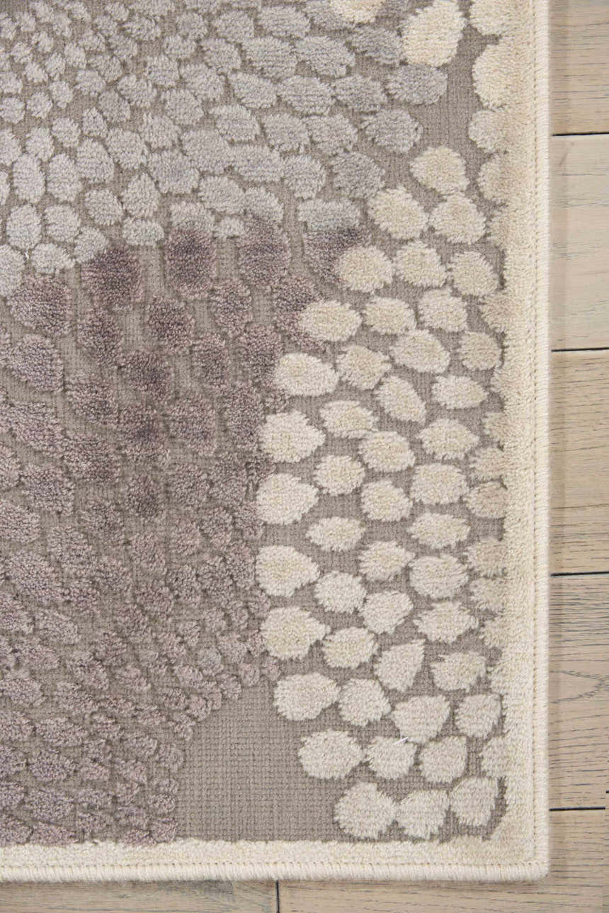 Close up of the Nourison Graphic Illusions Grey Mid-Century Modern rug, showing the textured dot pattern and soft gray hues.