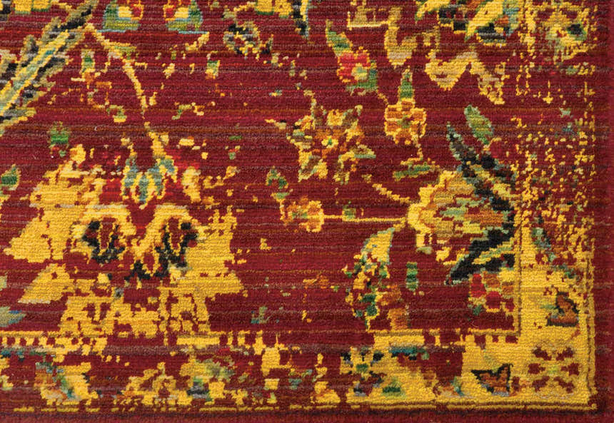 Close-up of the Nourison Timeless Pomegranate Persian Rug. Features a detailed floral pattern in reds, yellows, and greens.