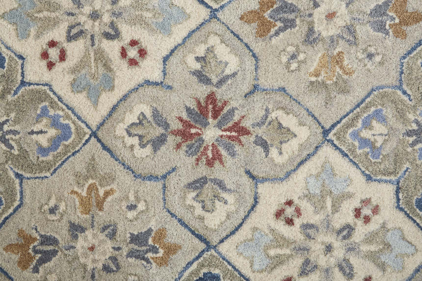 Close-up of the Feizy Rylan Taupe/Ivory/Red Area Rug. Floral and botanical pattern with taupe, ivory, red, and blue hues. Texture