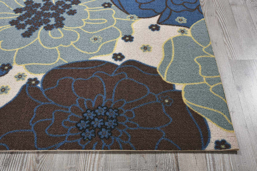 Close-up of the Nourison Home & Garden Light Blue rug. Contemporary floral design in light blue, brown, and yellow.