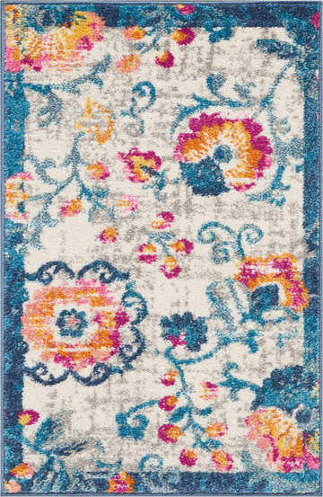 Close-up of Nourison Passion Ivory Bohemian rug. Features floral pattern with chestnut, pink, and blue hues. Soft texture.