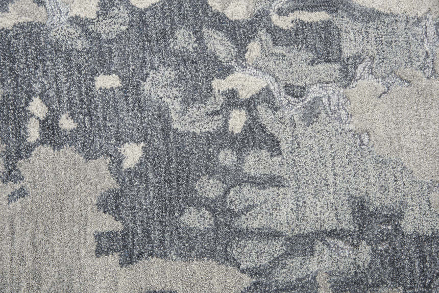 Close-up of the hand-tufted Rizzy VOG109 area rug. Contemporary design in gray and medium gray wool. Abstract pattern. Texture