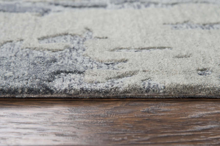 Close-up of the hand-tufted Rizzy VOG109 area rug. Gray and medium gray wool with a subtle contemporary pattern. Pile