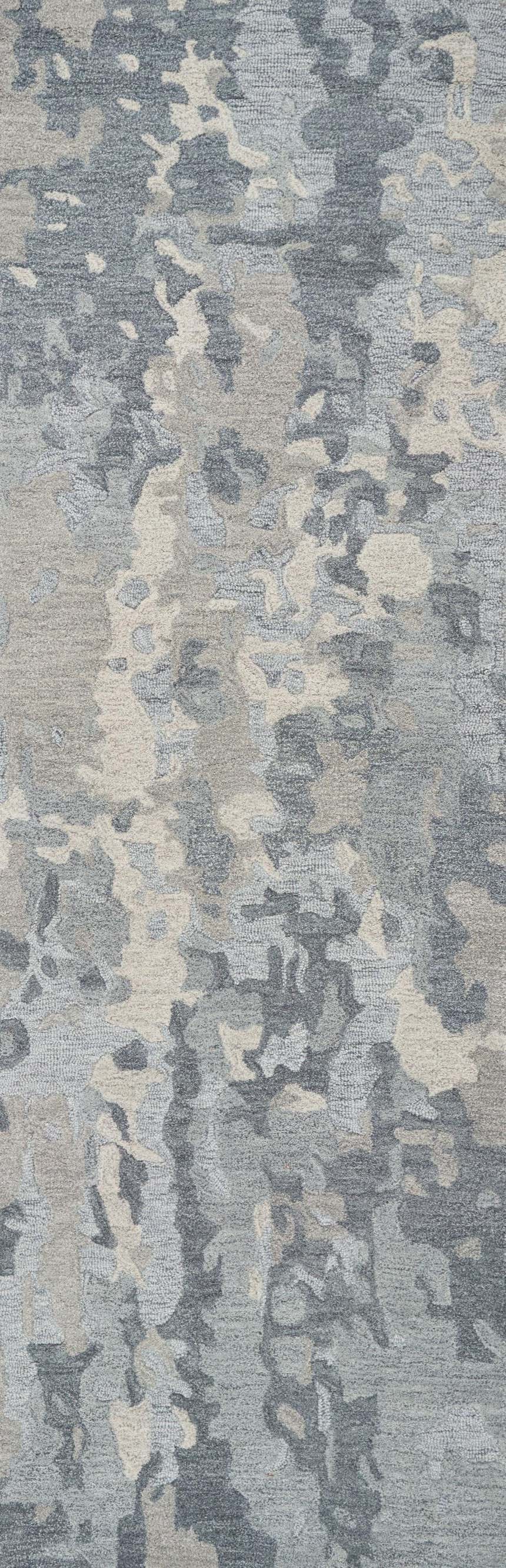 Close-up of the hand-tufted Rizzy VOG109 area rug. Contemporary style, gray, medium gray, and beige abstract pattern. 100% wool. Design-Runner