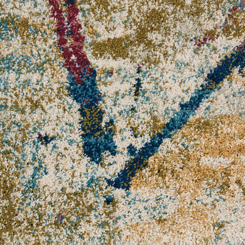 Close-up of Nourison Fusion Cream Multicolor rug. Abstract design with cream, blue, gold, and burgundy hues. Soft, textured pile.