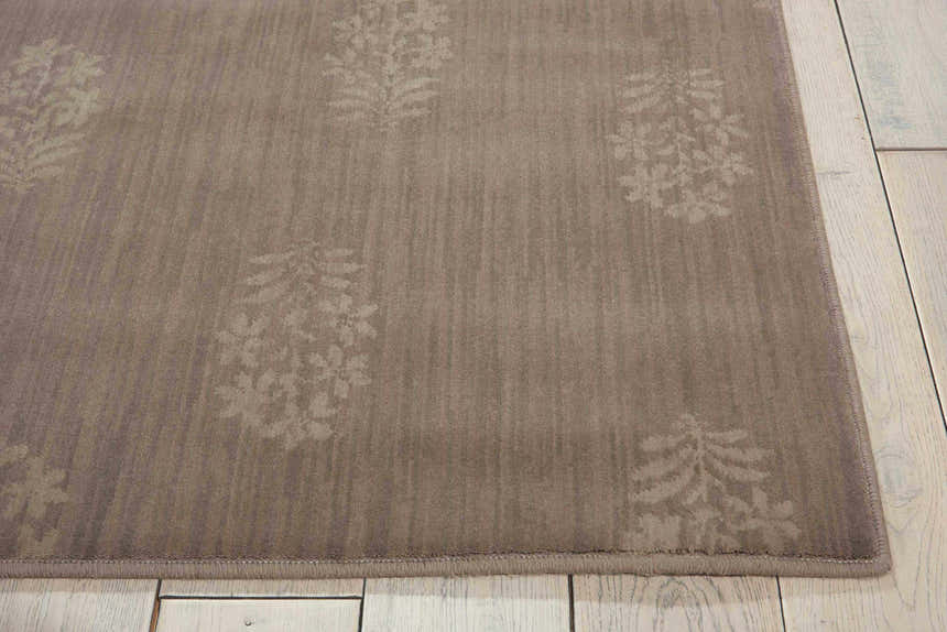 Close-up of the Calvin Klein Home Loom Select Neutrals Granite rug, showing its gray color and subtle floral pattern.