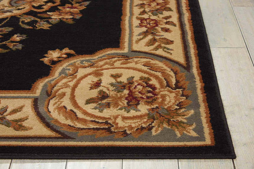 Close-up of Nourison Paramount Black Vintage Area Rug showing floral pattern and border detail.