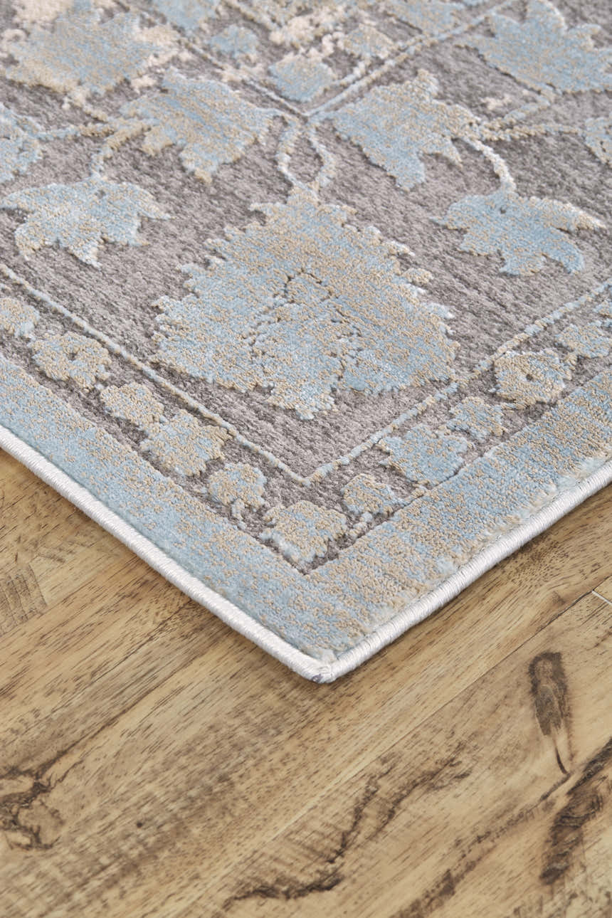 Close up of Feizy Prasad rug, blue, taupe and ivory floral pattern, distressed modern design. Corner